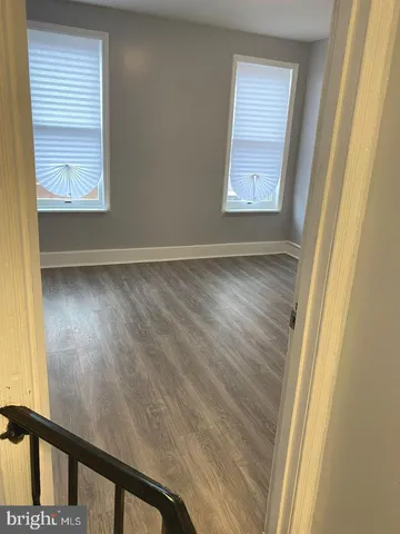 a view of an empty room and wooden floor