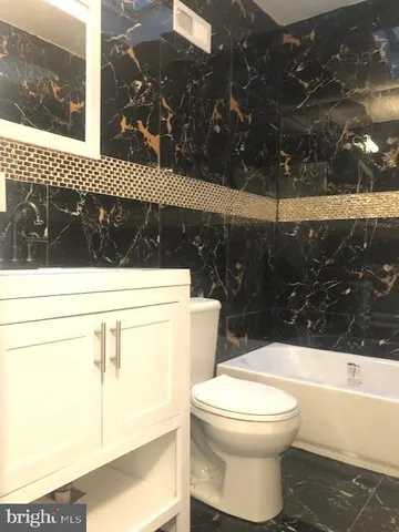 a bathroom with a toilet a sink and a shower