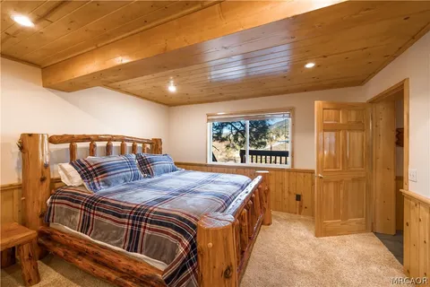 a bed sitting in a bedroom next to a window