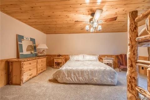 a spacious bedroom with a bed and a chandelier