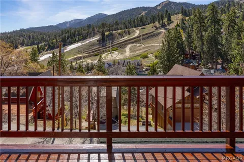 a view of a balcony with a yard