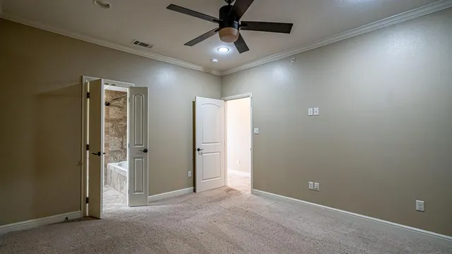 a view of a livingroom with a ceiling fan & a window