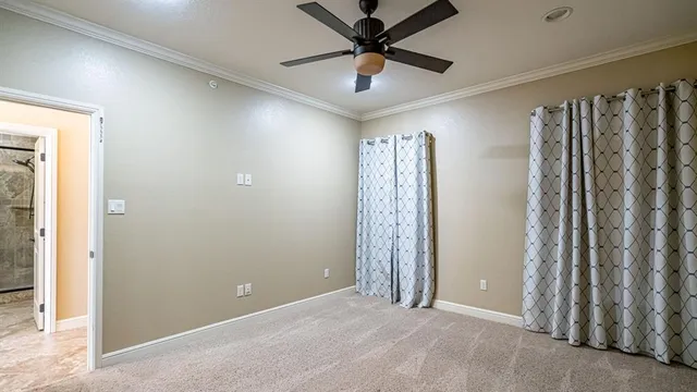 an empty room with closet and windows