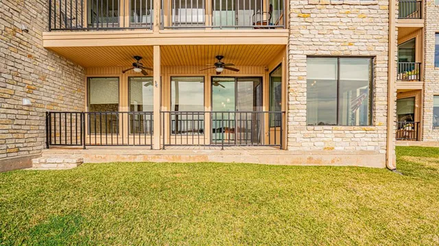 a bathroom with a granite countertop sink a toilet a mirror a shower and vanity