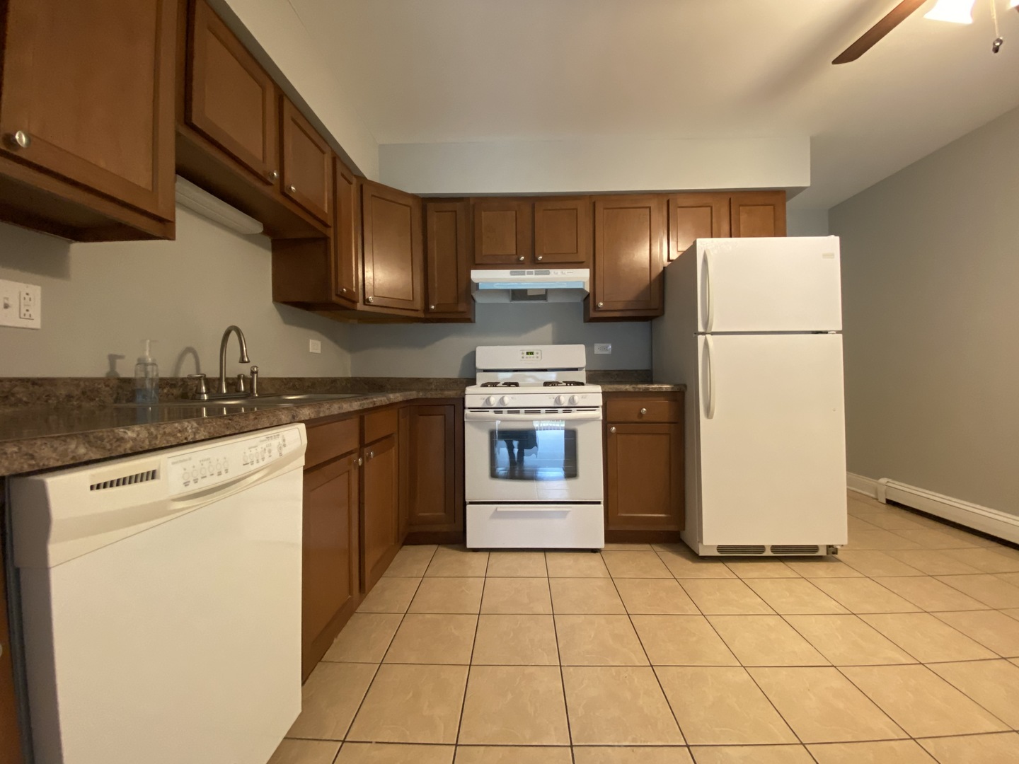 9368 Golf Road, Unit 1A Des Plaines, IL 60016 - Photo 5 of 21 a kitchen with a stove top oven cabinets and a refrigerator