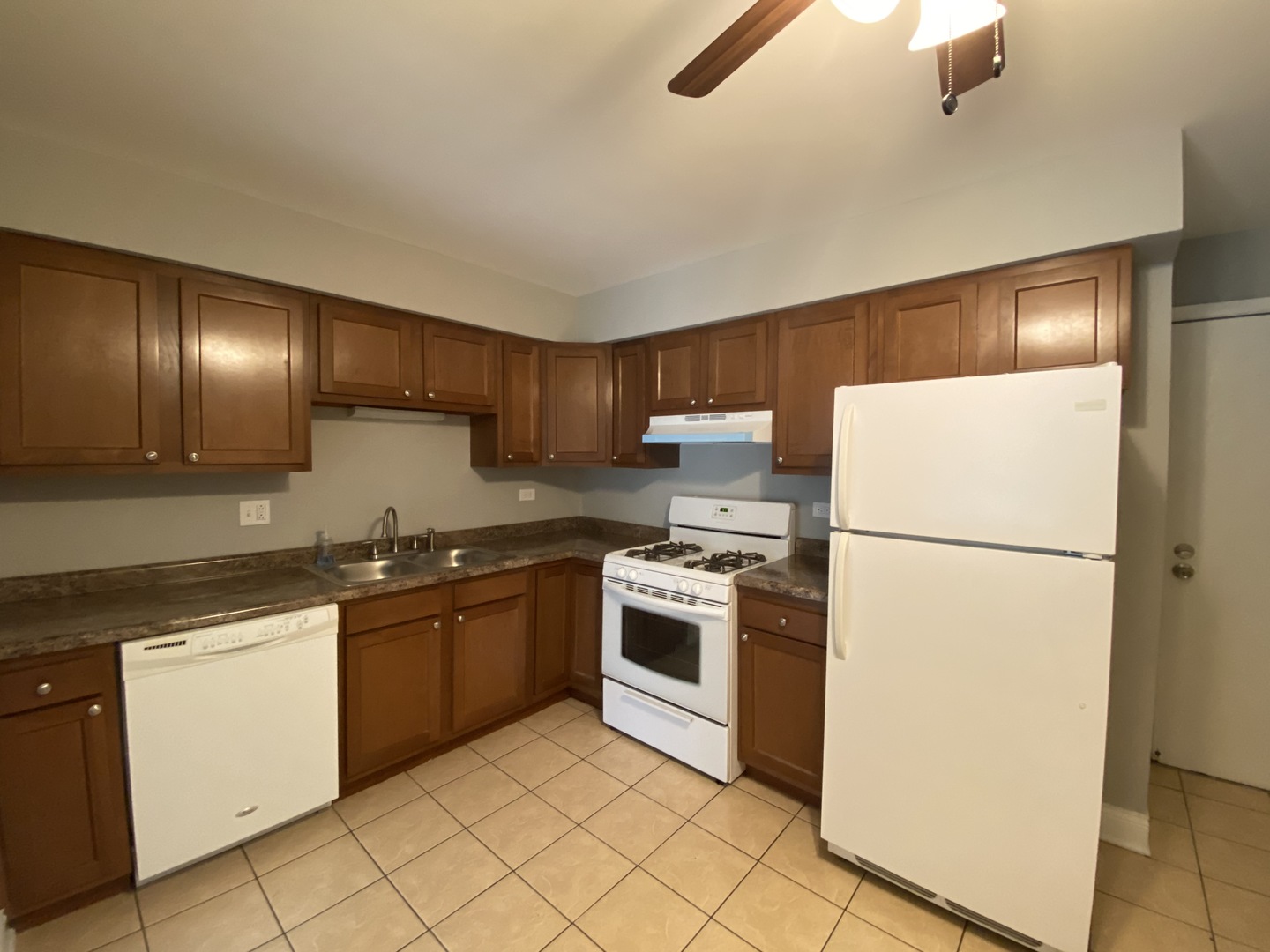 9368 Golf Road, Unit 1A Des Plaines, IL 60016 - Photo 6 of 21 a kitchen with granite countertop stainless steel appliances and white cabinets