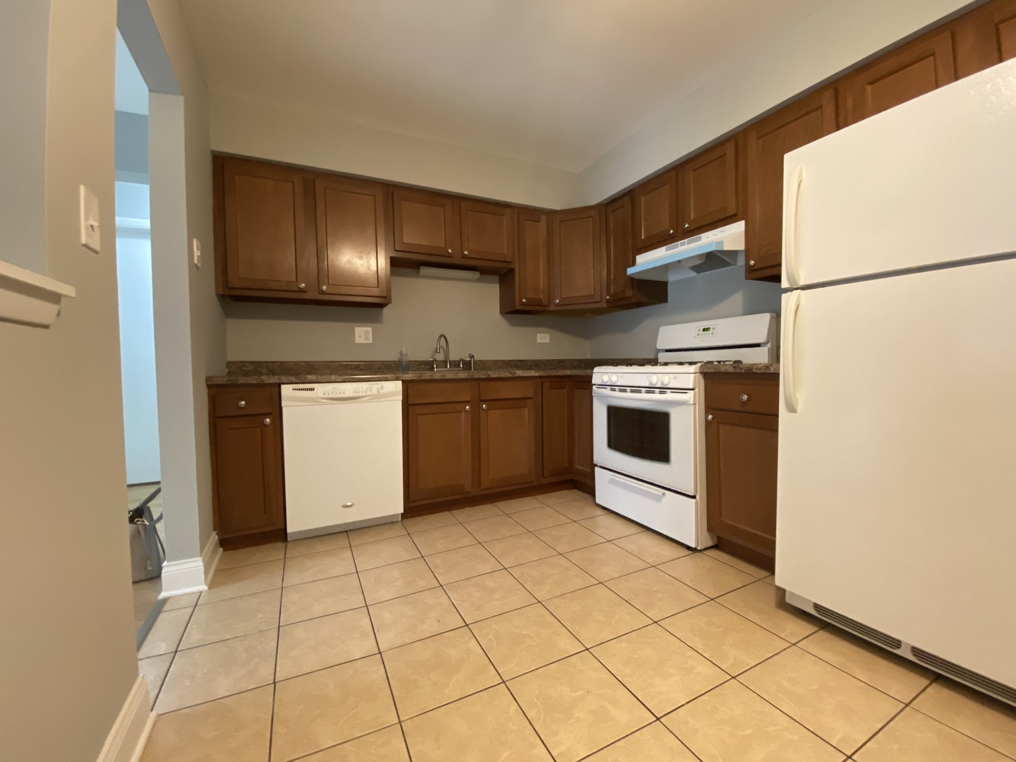 9368 Golf Road, Unit 1A Des Plaines, IL 60016 - Photo 7 of 21 a kitchen with stainless steel appliances granite countertop a stove a sink and a refrigerator