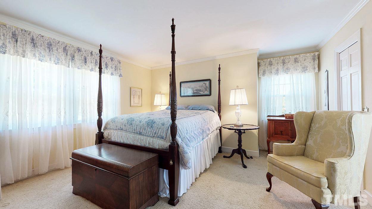 3322 Dick Holeman Road Timberlake, NC 27583 - Photo 12 of 30 a bedroom with a bed a couch and a window