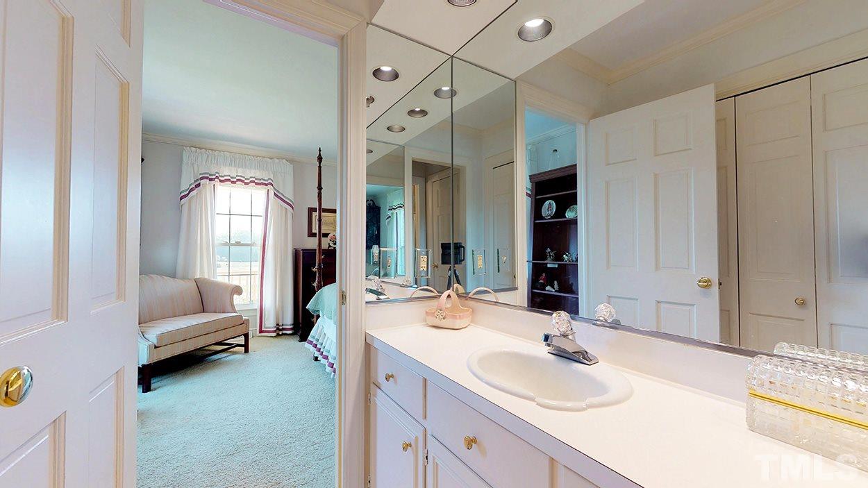 3322 Dick Holeman Road Timberlake, NC 27583 - Photo 15 of 30 a bathroom with a double vanity sink mirror and bathtub