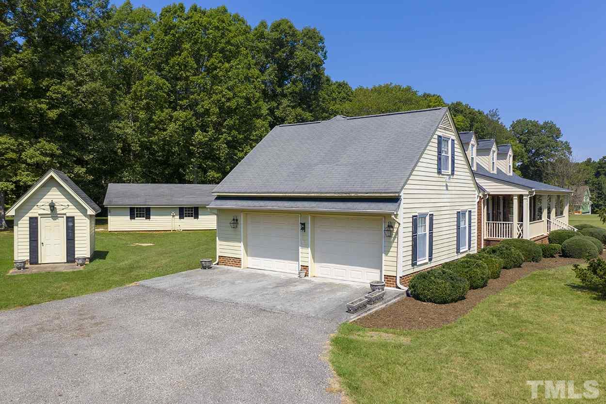 3322 Dick Holeman Road Timberlake, NC 27583 - Photo 24 of 30 a front view of a house with a yard and garage