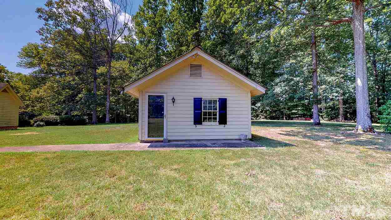 3322 Dick Holeman Road Timberlake, NC 27583 - Photo 26 of 30 a view of backyard of house with large trees