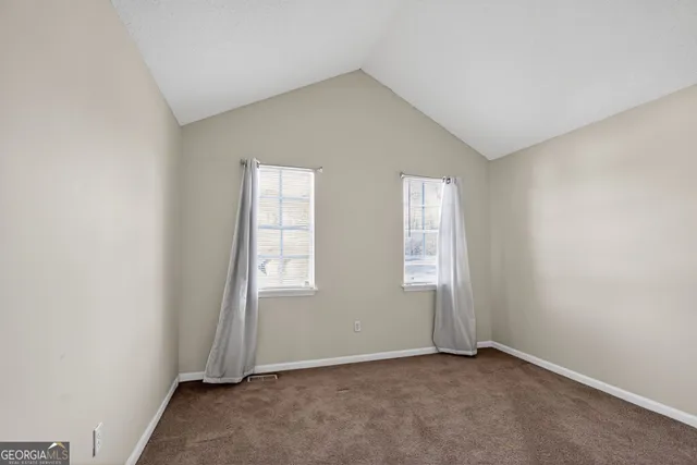 a view of a livingroom with a ceiling fan and window
