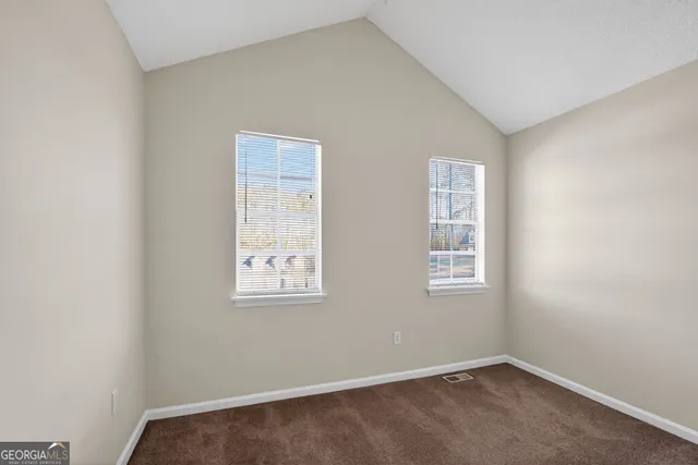 an empty room with closet area