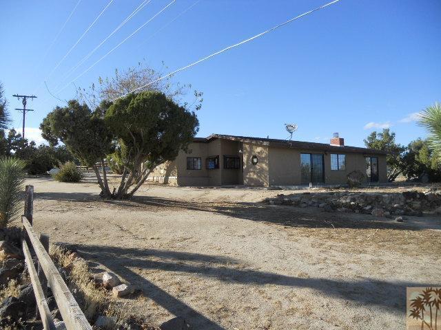 56950 Spencer Road Yucca Valley, CA 92284 - Photo 1 of 9 a view of a house with a yard