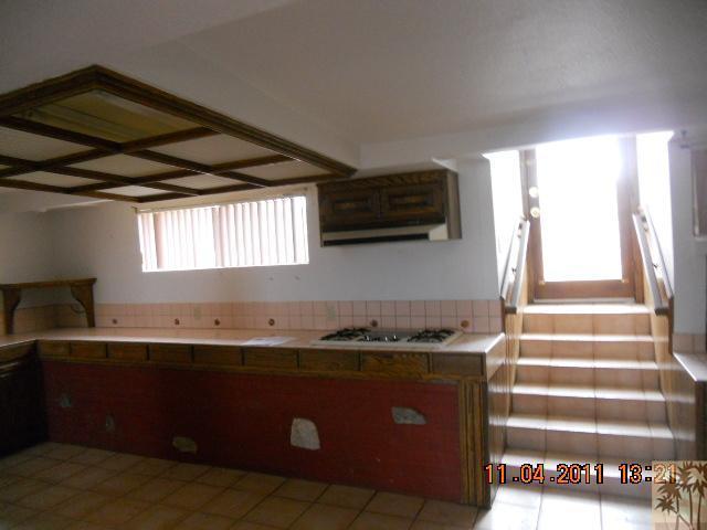 56950 Spencer Road Yucca Valley, CA 92284 - Photo 5 of 9 a kitchen with granite countertop a sink a stove and a microwave