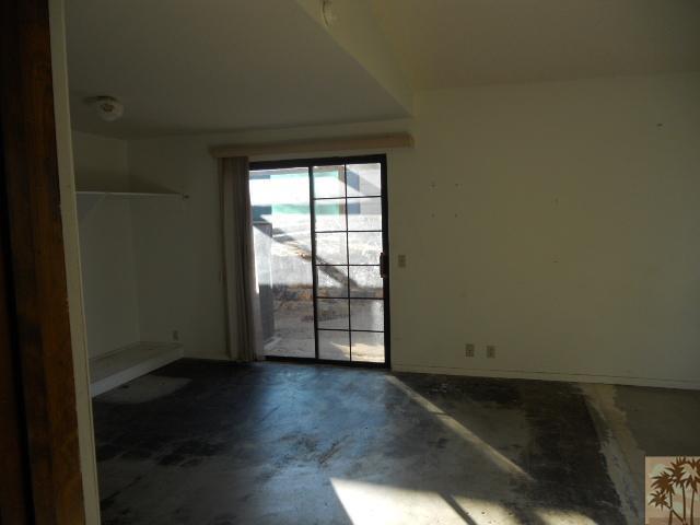 56950 Spencer Road Yucca Valley, CA 92284 - Photo 6 of 9 an empty room with wooden floor and windows