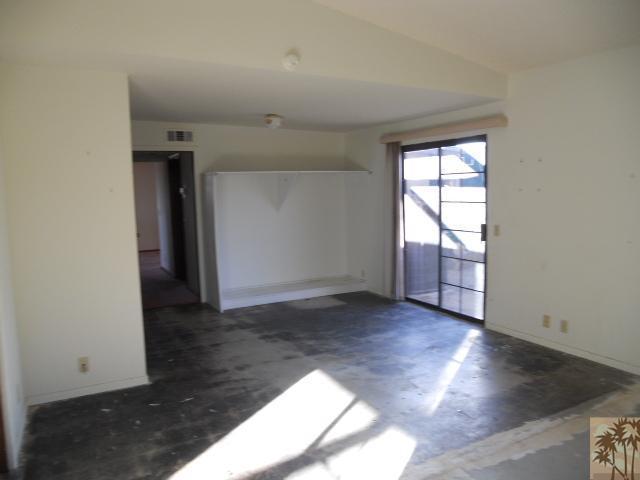 56950 Spencer Road Yucca Valley, CA 92284 - Photo 7 of 9 an empty room with wooden floor and windows