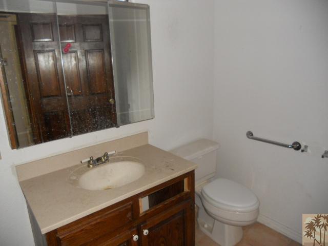 56950 Spencer Road Yucca Valley, CA 92284 - Photo 8 of 9 a bathroom with a sink toilet and mirror
