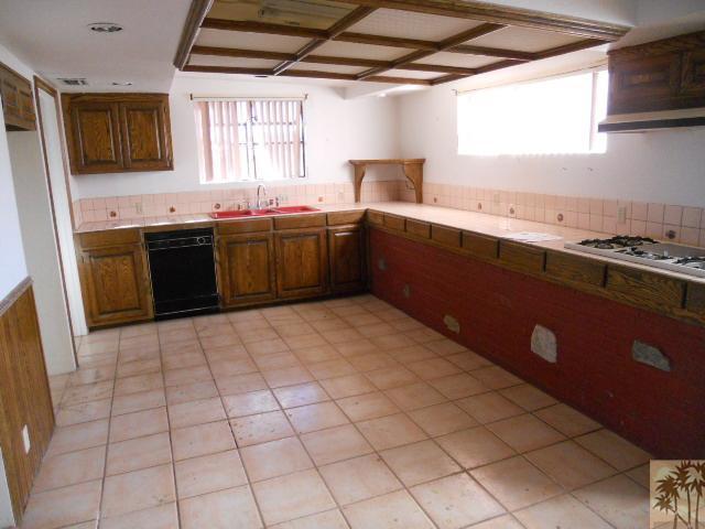56950 Spencer Road Yucca Valley, CA 92284 - Photo 9 of 9 a kitchen with stainless steel appliances a sink stove and window