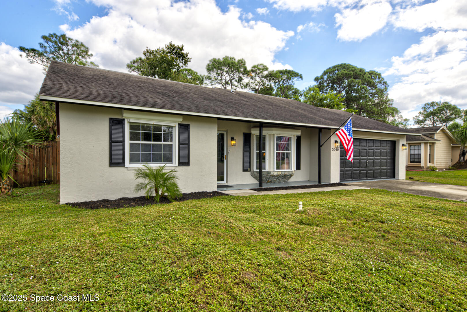 5049 Jamaica Road Cocoa, FL 32927 - Photo 1 of 24 a front view of house with yard and green space