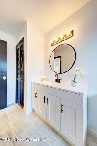 a bathroom with a double vanity sink and a mirror