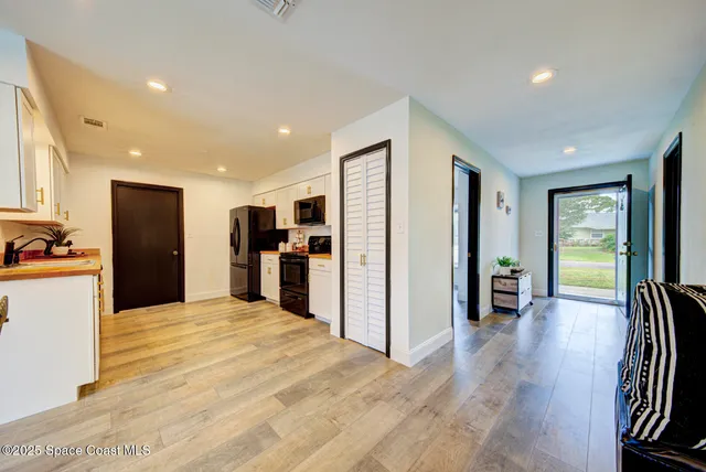 a view of a kitchen with refrigerator and a dining table