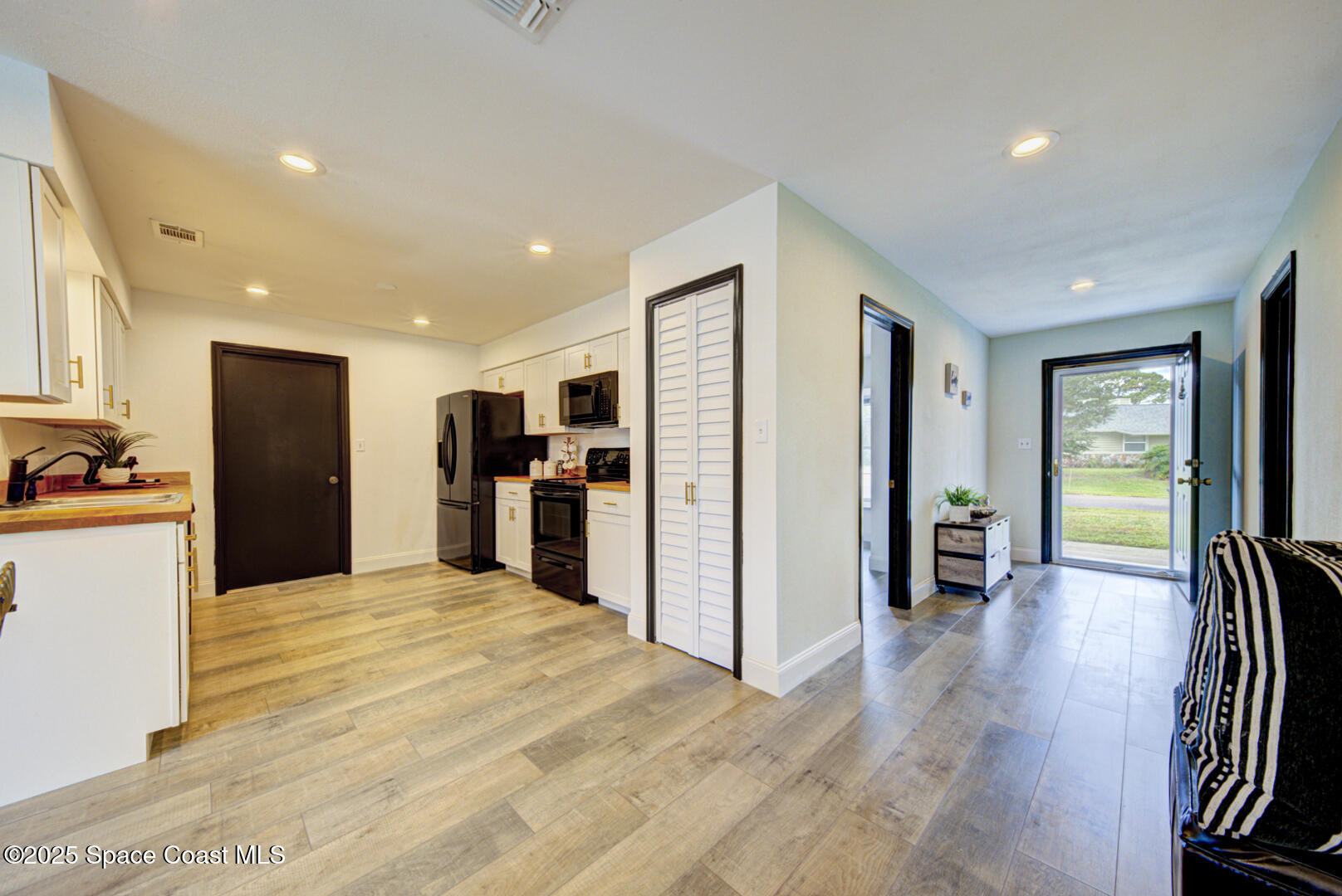 5049 Jamaica Road Cocoa, FL 32927 - Photo 12 of 24 a view of a kitchen with refrigerator and a dining table