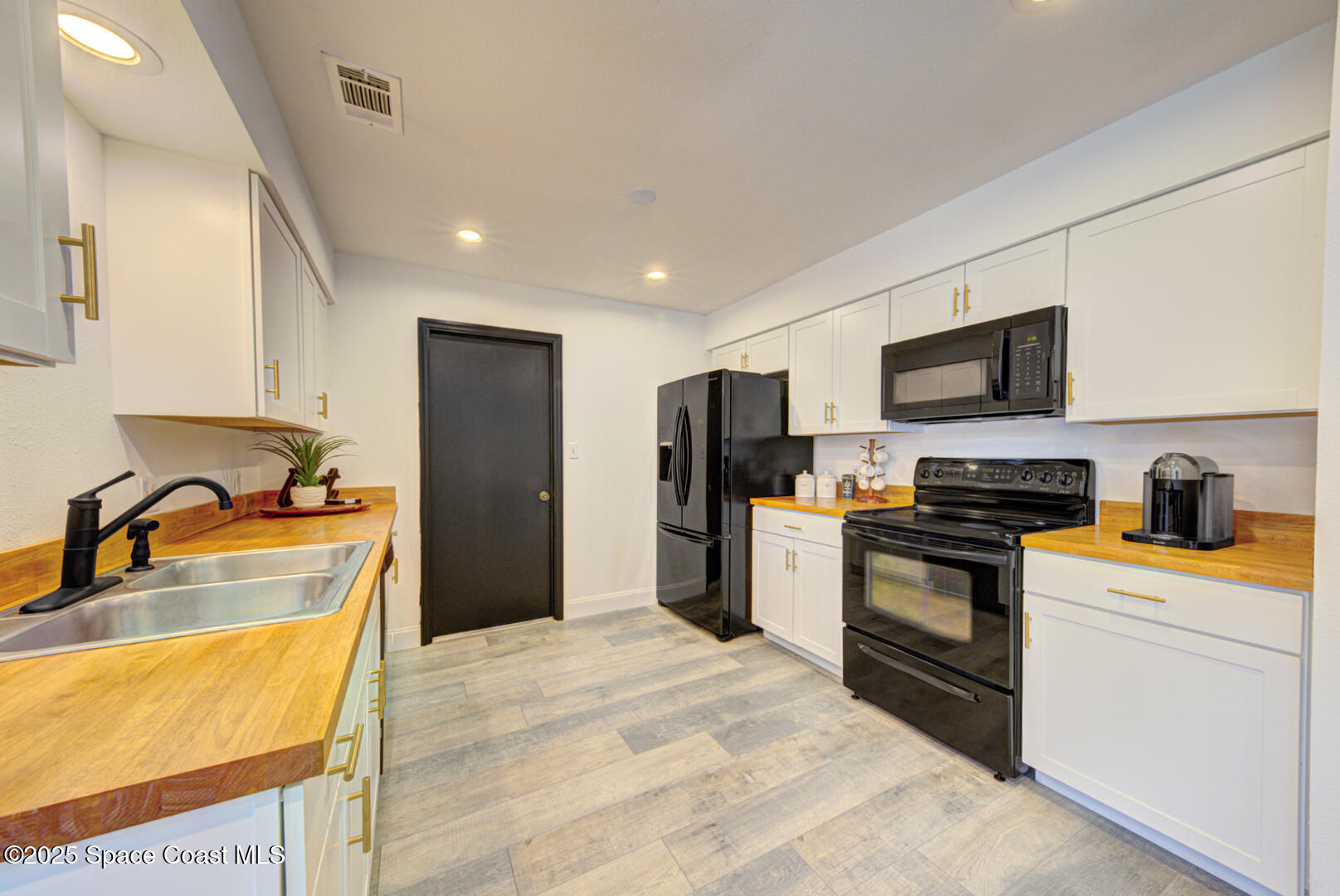5049 Jamaica Road Cocoa, FL 32927 - Photo 13 of 24 a kitchen with granite countertop a refrigerator and a stove top oven