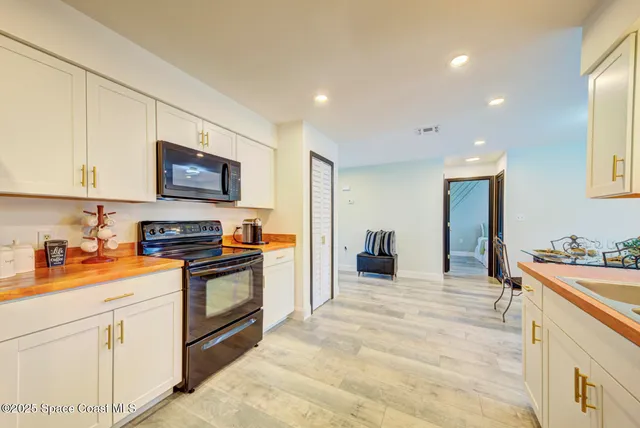a kitchen with stainless steel appliances granite countertop a sink and cabinets