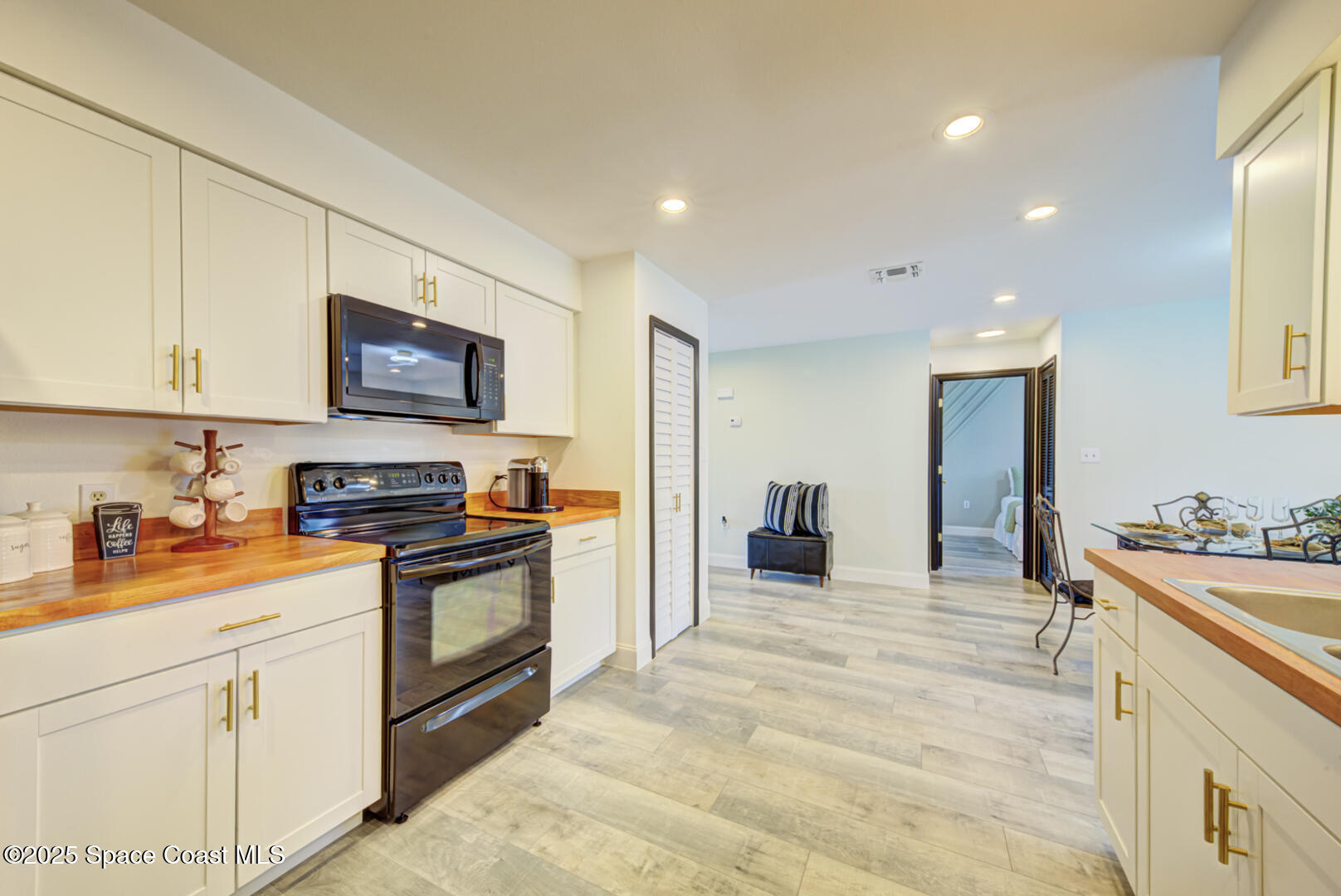 5049 Jamaica Road Cocoa, FL 32927 - Photo 14 of 24 a kitchen with stainless steel appliances granite countertop a sink and cabinets