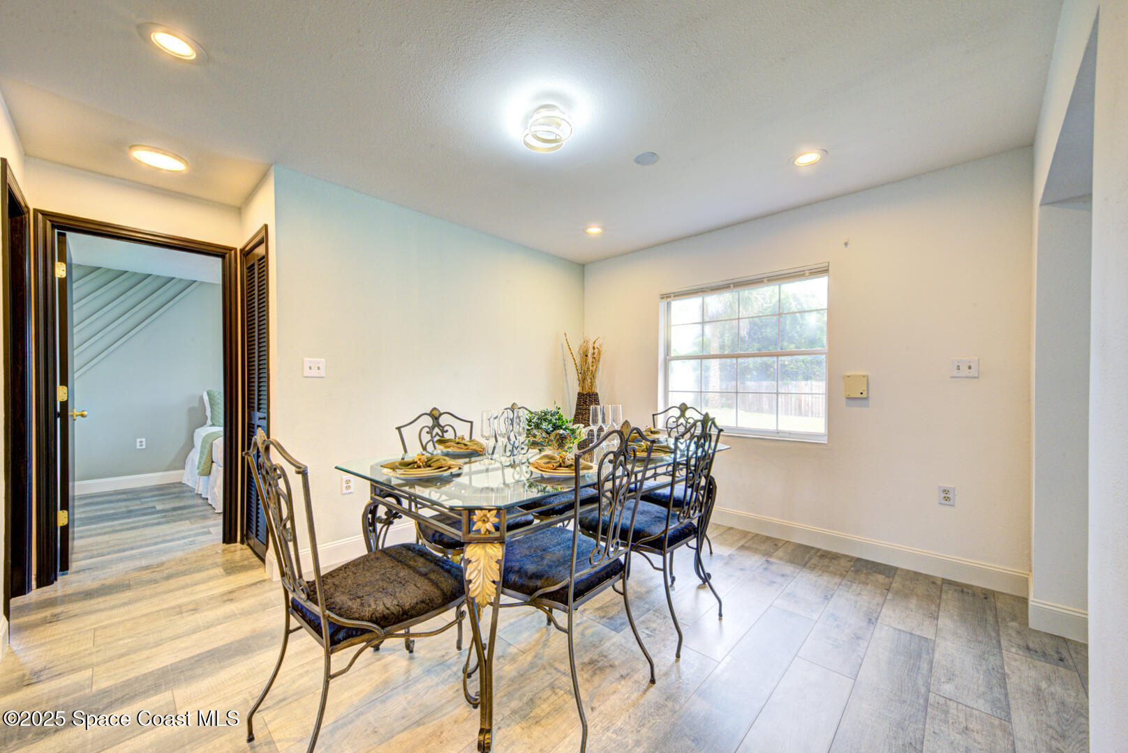 5049 Jamaica Road Cocoa, FL 32927 - Photo 15 of 24 a view of a dining room with furniture and wooden floor