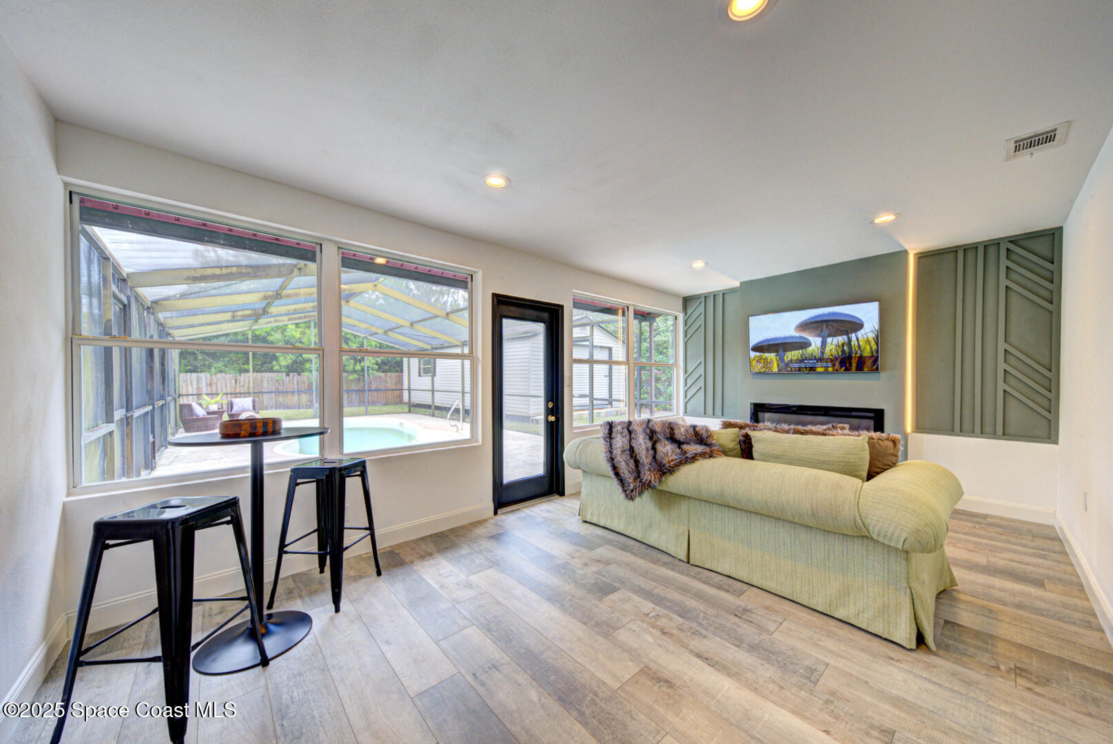 5049 Jamaica Road Cocoa, FL 32927 - Photo 16 of 24 a living room with furniture and a flat screen tv with wooden floor