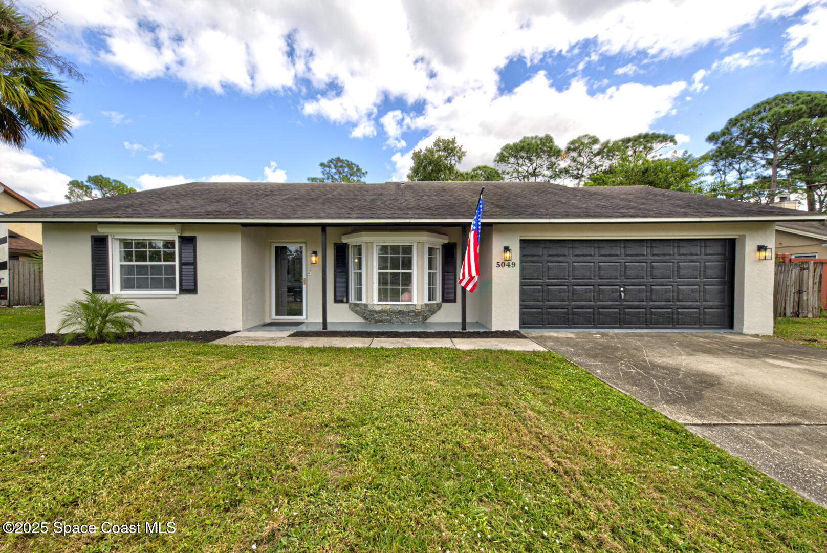 5049 Jamaica Road Cocoa, FL 32927 - Photo 2 of 24 a front view of a house with a yard