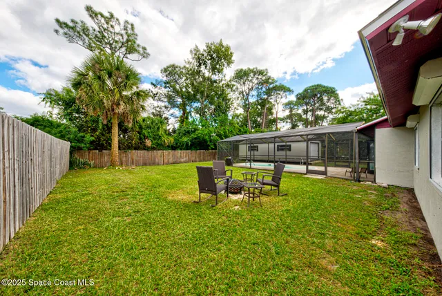 a view of a house with backyard sitting area and garden