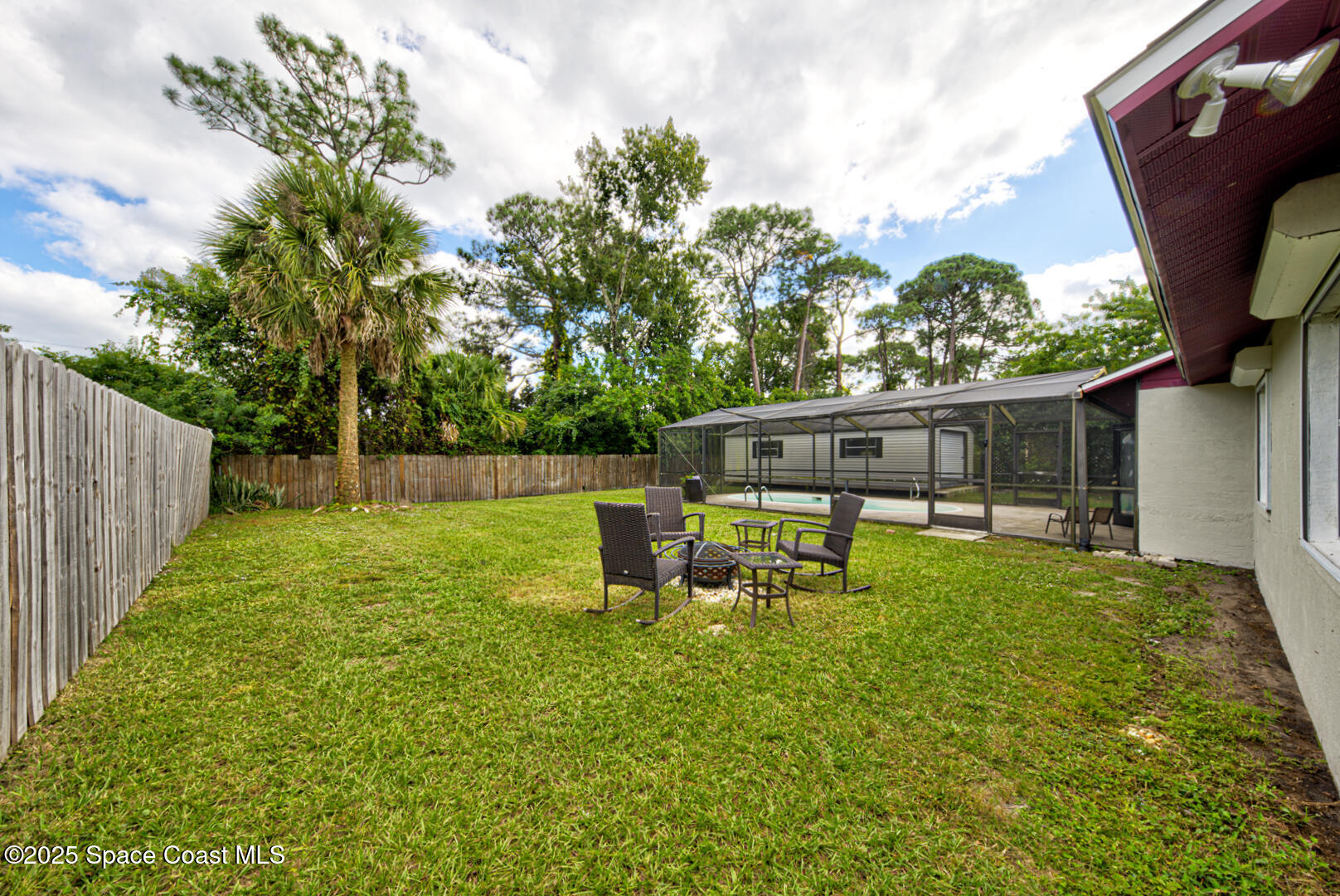 5049 Jamaica Road Cocoa, FL 32927 - Photo 23 of 24 a view of a house with backyard sitting area and garden