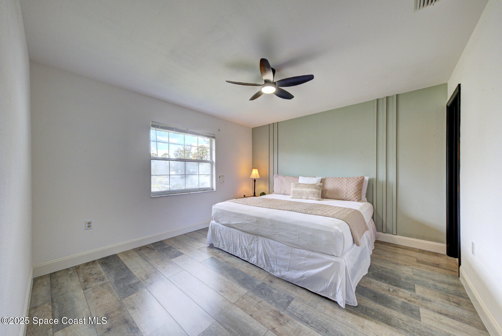 5049 Jamaica Road Cocoa, FL 32927 - Photo 4 of 24 a bedroom with a bed and window