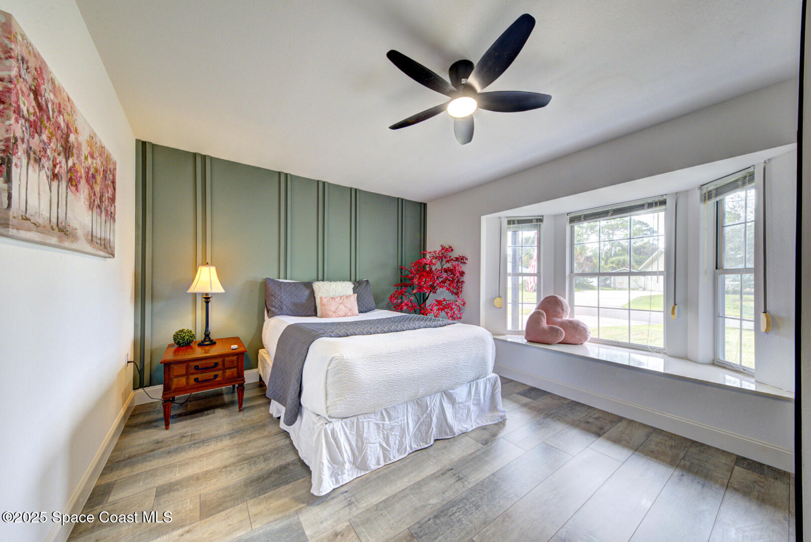 5049 Jamaica Road Cocoa, FL 32927 - Photo 5 of 24 a living room with a bed furniture and a large window