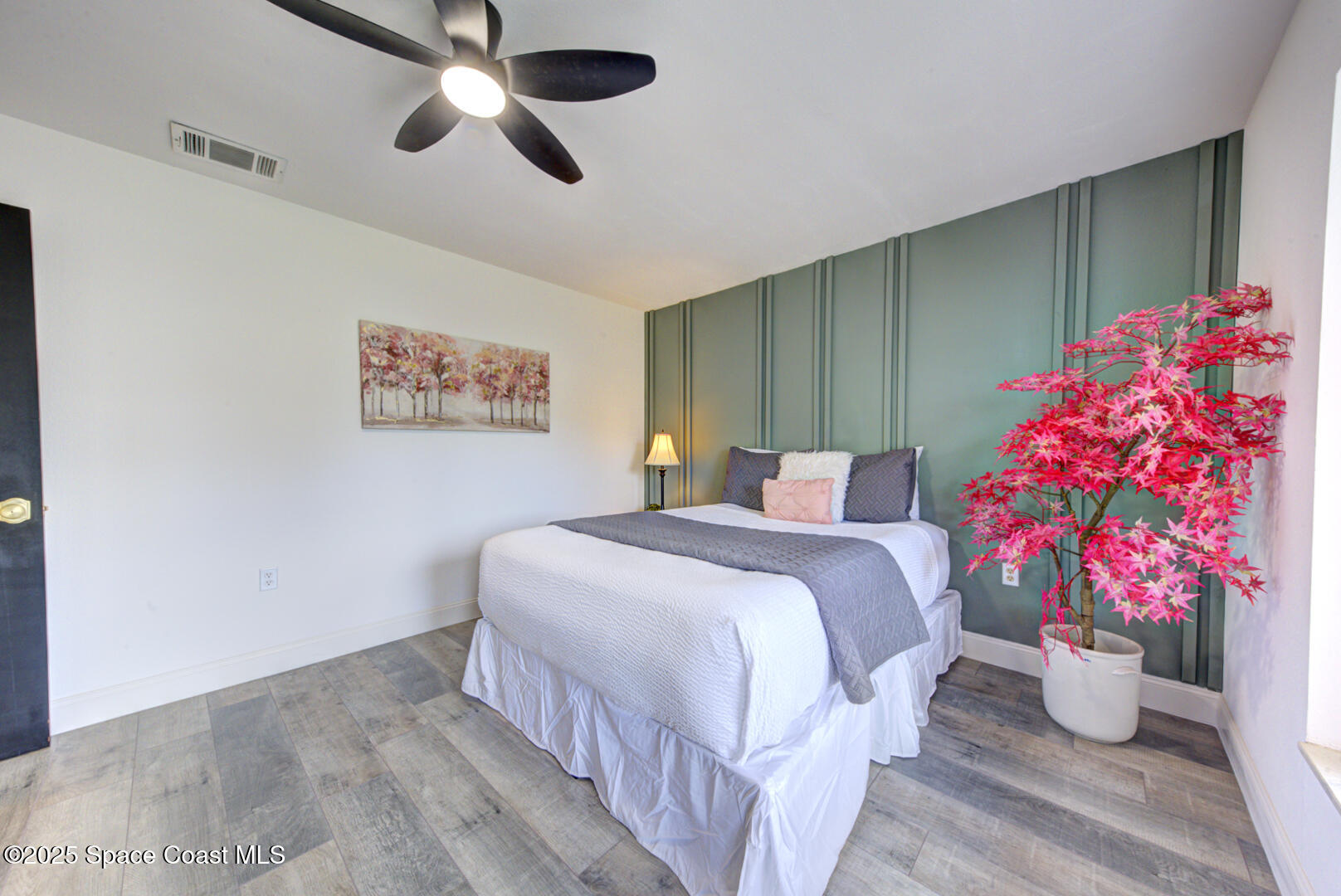 5049 Jamaica Road Cocoa, FL 32927 - Photo 6 of 24 a bedroom with a bed and a potted plant