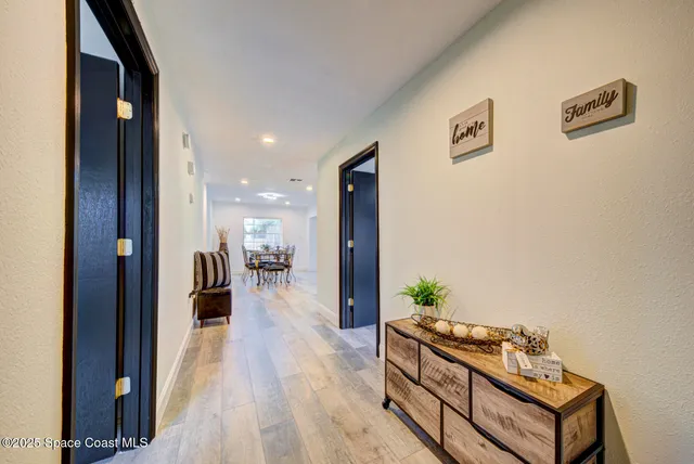 a hallway with a large mirror and a wooden floor