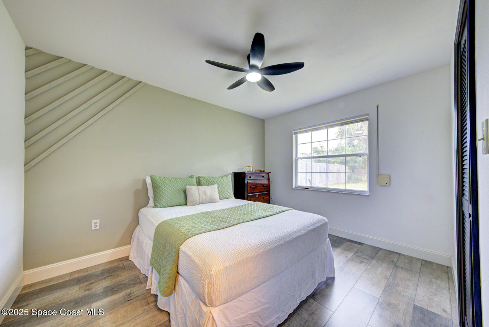 5049 Jamaica Road Cocoa, FL 32927 - Photo 8 of 24 a bedroom with a bed and a window