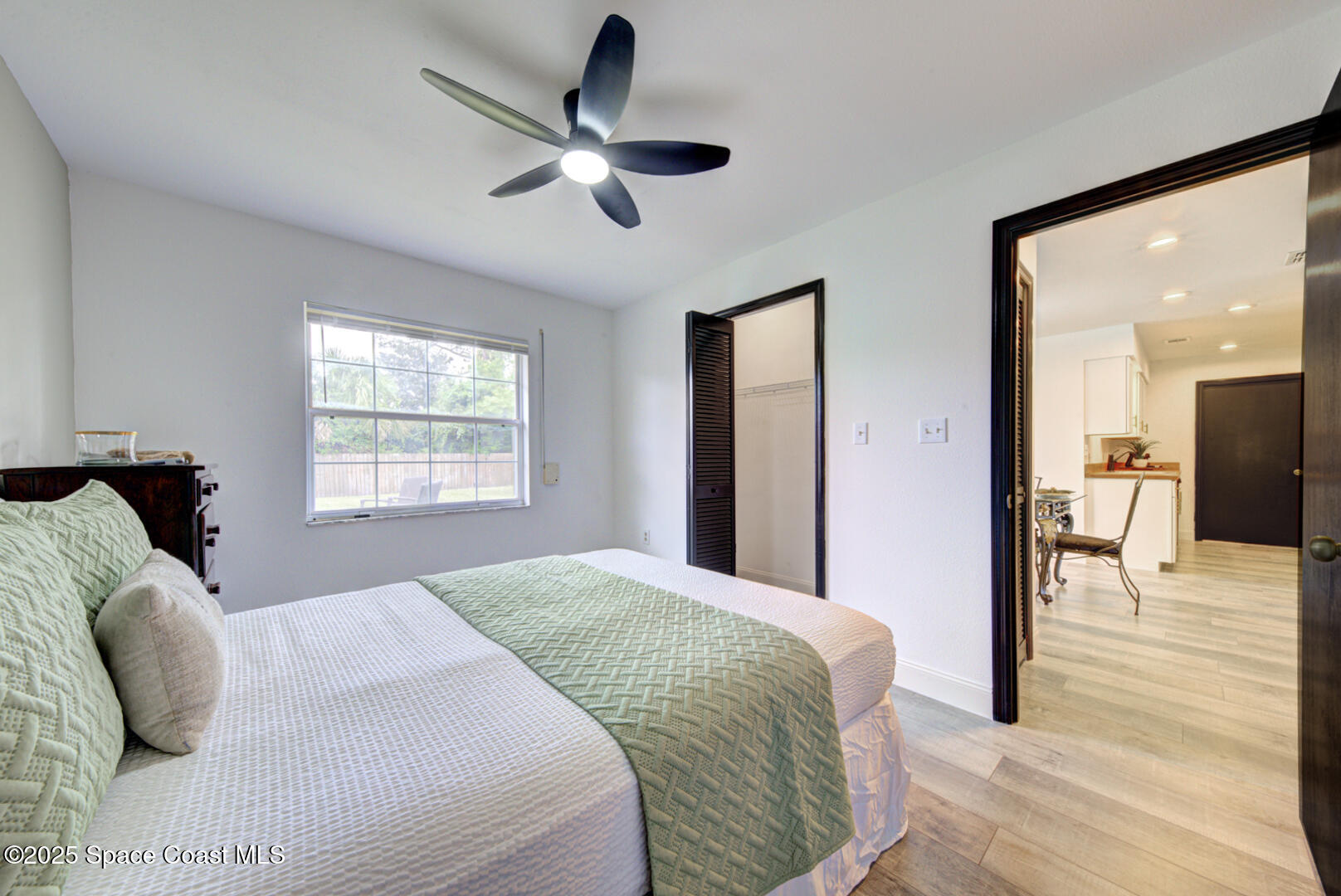 5049 Jamaica Road Cocoa, FL 32927 - Photo 9 of 24 a bedroom with a bed and a chandelier