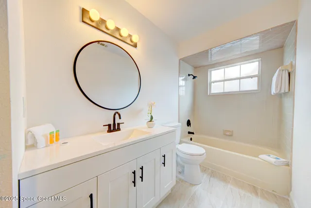 a bathroom with a toilet a sink and a bathtub