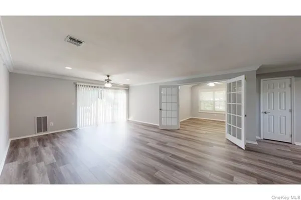 a view of an empty room and wooden floor