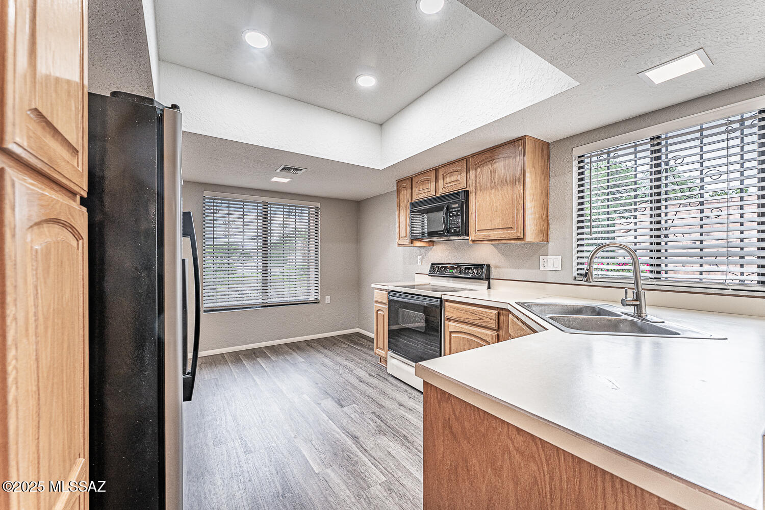931 West Rio Guaymas Green Valley, AZ 85614 - Photo 12 of 39 a kitchen with stainless steel appliances granite countertop a sink stove and refrigerator
