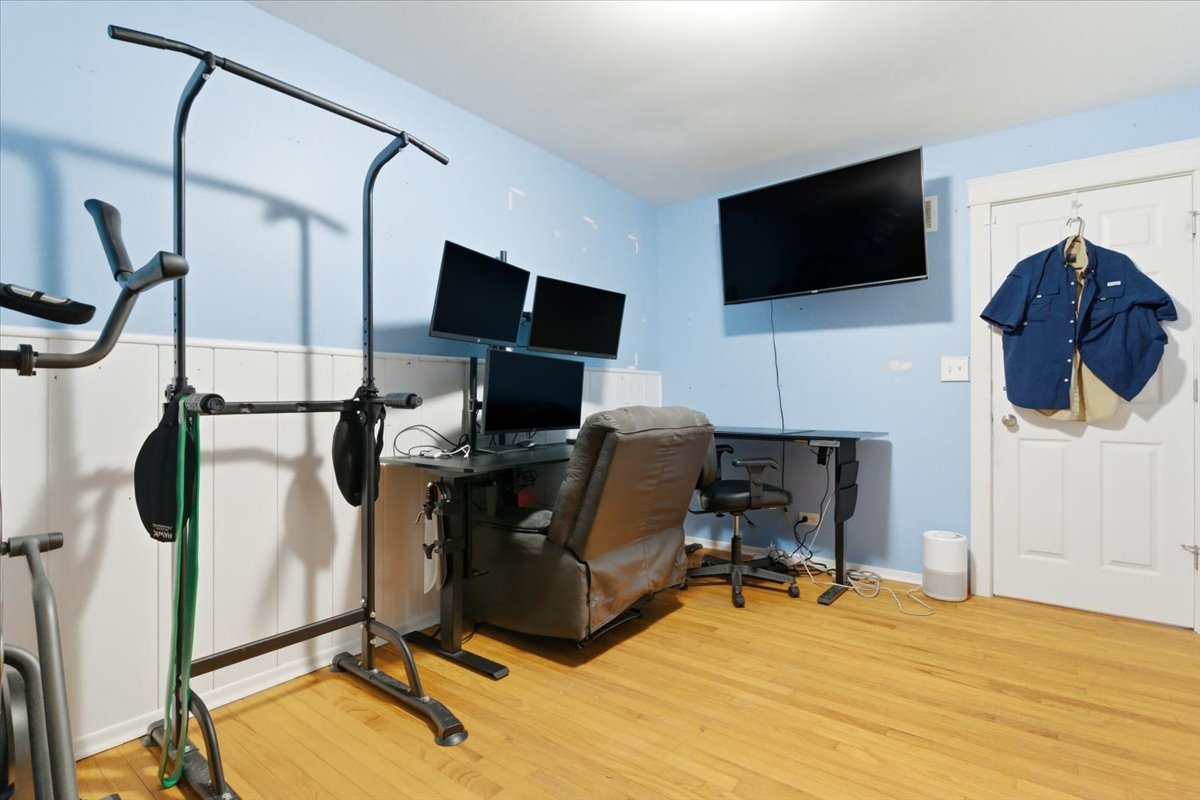 2105 Sprucewood Lane Lindenhurst, IL 60046 - Photo 17 of 37 a view of a workspace with furniture and a flat screen tv