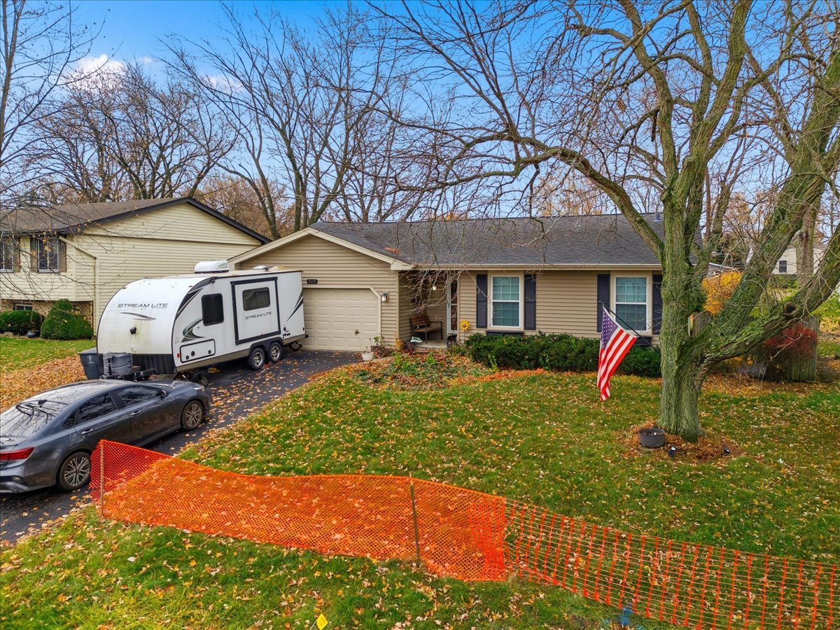 2105 Sprucewood Lane Lindenhurst, IL 60046 - Photo 25 of 37 a front view of a house with a yard and garage