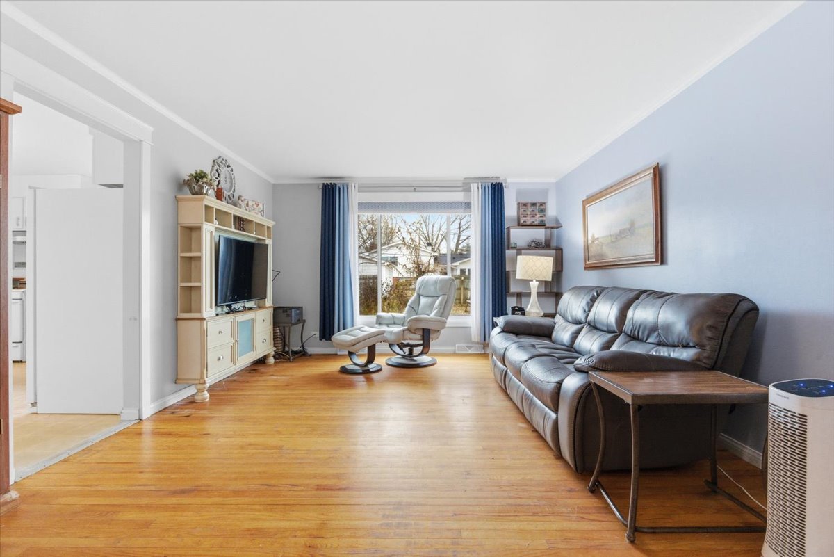 2105 Sprucewood Lane Lindenhurst, IL 60046 - Photo 6 of 37 a living room with furniture large window and flat screen tv