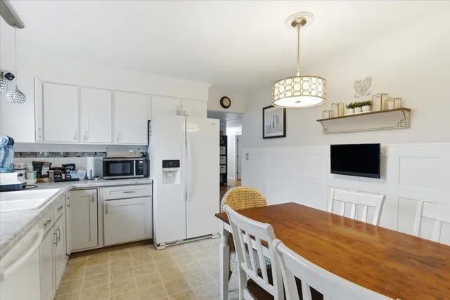a kitchen that has a lot of cabinets and stainless steel appliances