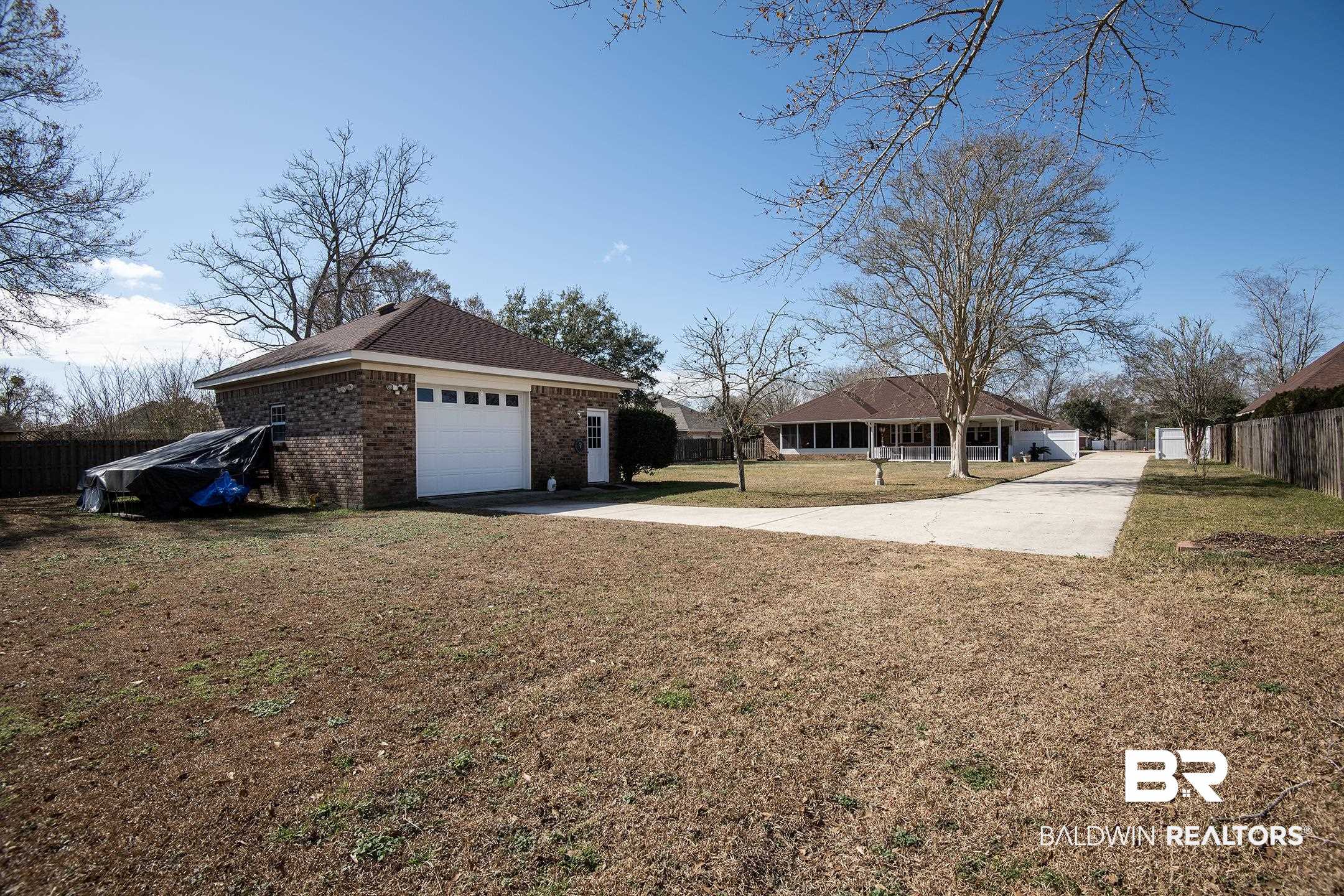 12626 Hunters Chase Foley, AL 36535 - Photo 38 of 40 View of side of home featuring brick siding, driveway, and an attached garage