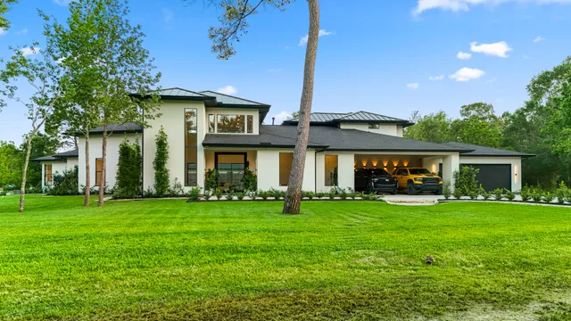 a view of a house with a yard and sitting area